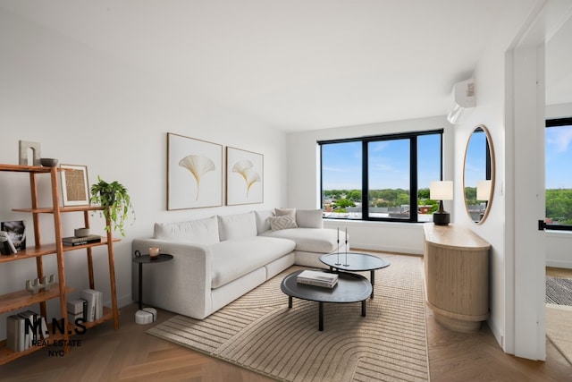 living area with baseboards and a wall mounted air conditioner