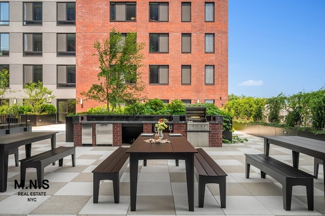 view of community with area for grilling, a patio, and outdoor dining area