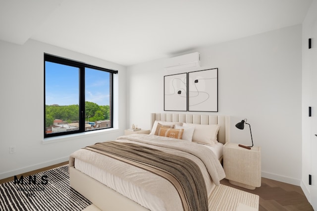 bedroom featuring an AC wall unit and baseboards