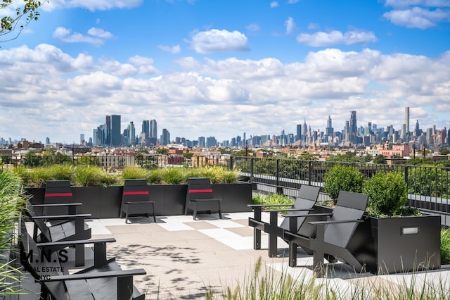view of community with fence, a city view, and a patio area