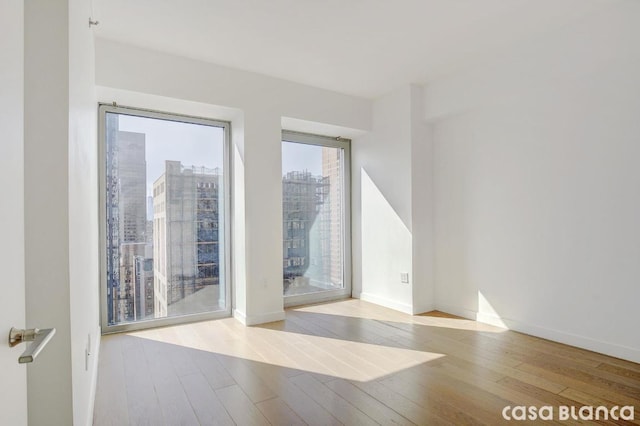 spare room with light hardwood / wood-style flooring