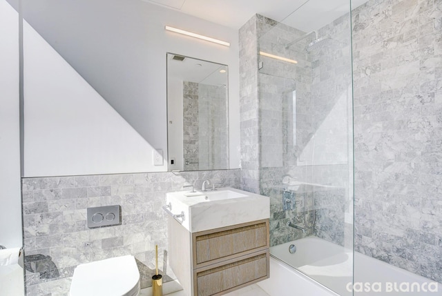 full bathroom featuring shower / bath combination, tile walls, toilet, and vanity