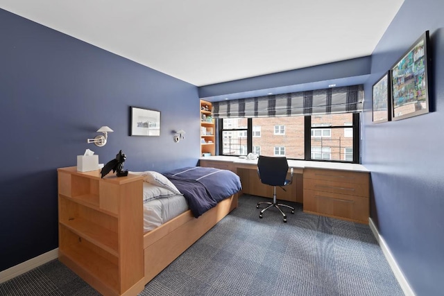 bedroom featuring carpet and built in desk