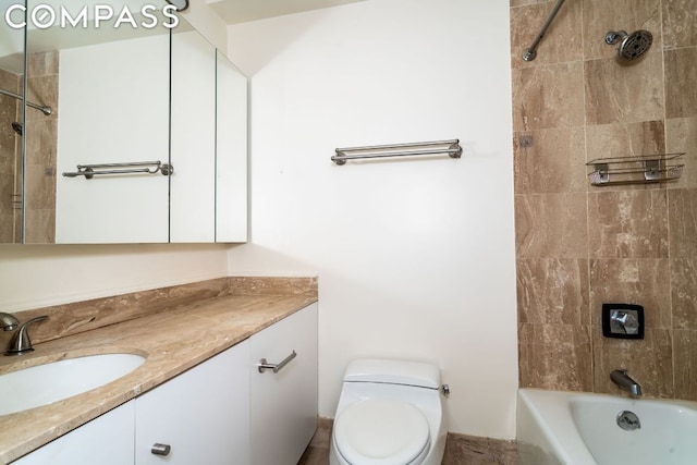 full bathroom featuring toilet, vanity, and tiled shower / bath combo