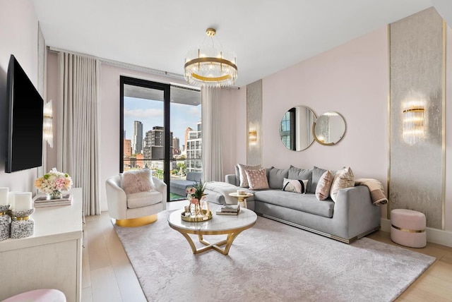 living area featuring light wood-type flooring, a city view, and a notable chandelier