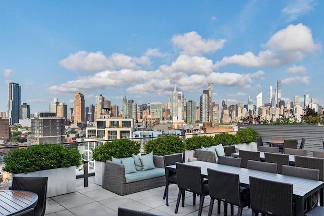 view of patio / terrace with outdoor dining area and a city view