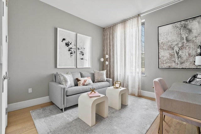 living room featuring light wood-style floors and baseboards