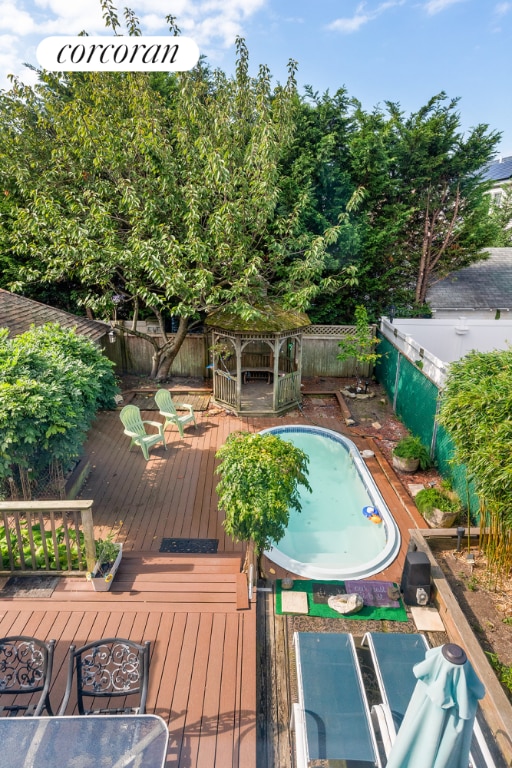 view of pool with a deck and a gazebo