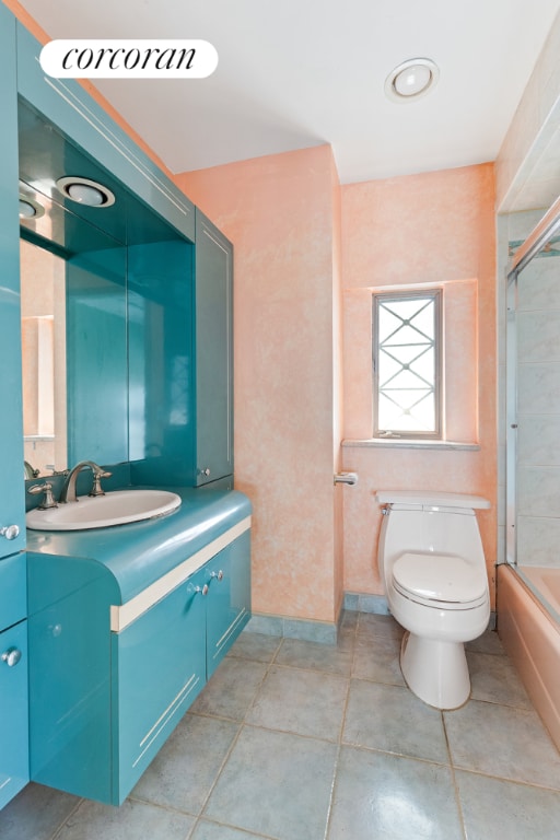 full bathroom featuring toilet, bath / shower combo with glass door, and vanity