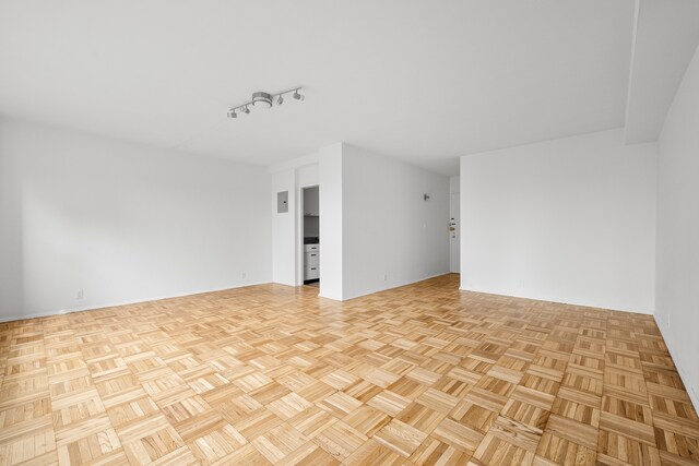 spare room featuring light parquet flooring and radiator heating unit