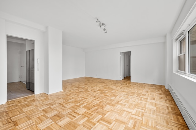 unfurnished room with a baseboard radiator