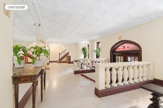 hallway featuring crown molding and a textured ceiling