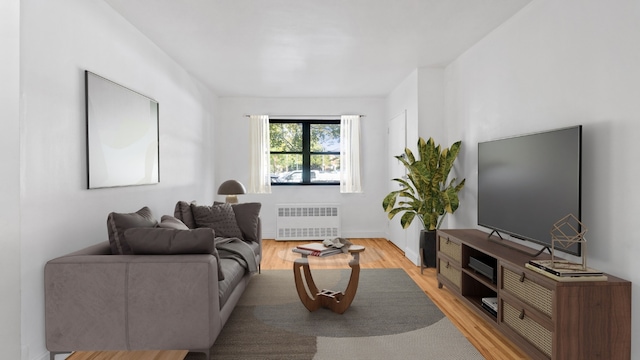 living room with light hardwood / wood-style floors and radiator heating unit