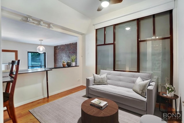 living room featuring ceiling fan and light hardwood / wood-style flooring