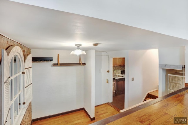 corridor with light hardwood / wood-style flooring