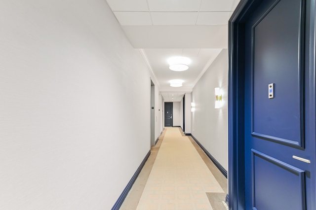 corridor featuring baseboards and ornamental molding