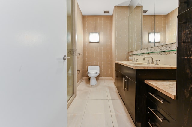 bathroom featuring tile walls, tile patterned flooring, vanity, toilet, and walk in shower