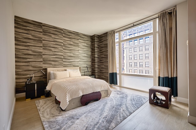 bedroom with baseboards and wood finished floors