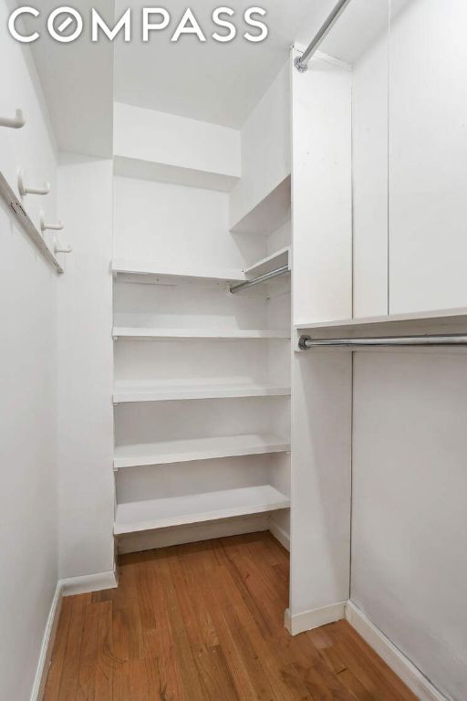 spacious closet featuring hardwood / wood-style floors