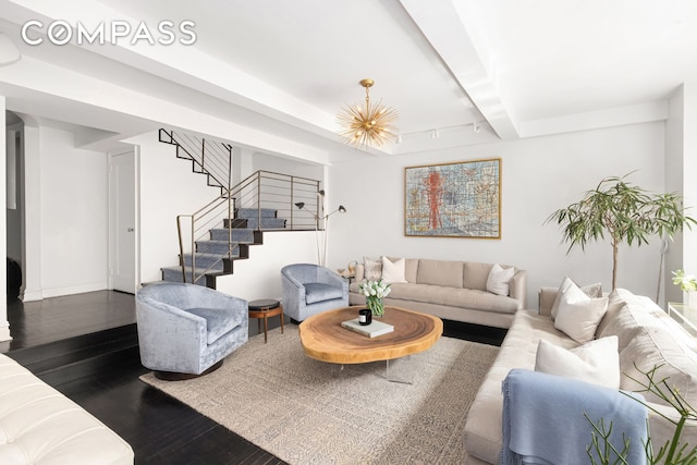 living room with dark wood-style floors, beam ceiling, stairway, and baseboards