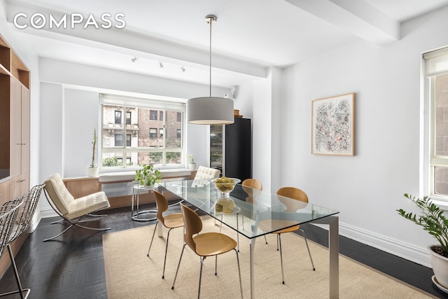 dining room featuring dark wood finished floors and baseboards