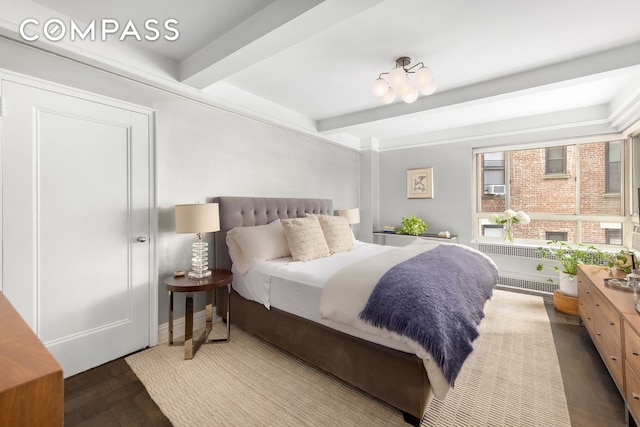 bedroom with beamed ceiling and radiator heating unit