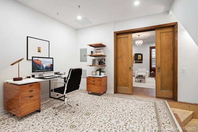 office with an inviting chandelier, electric panel, and light wood-type flooring