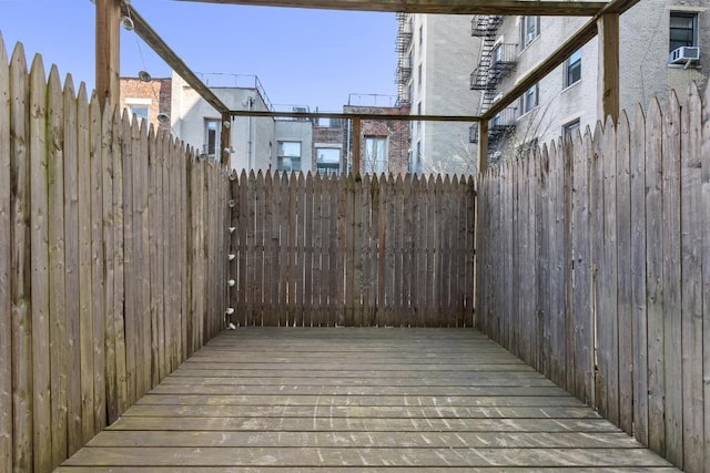 wooden terrace featuring cooling unit