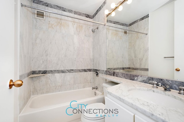 bathroom featuring visible vents, toilet, shower / bath combination, and vanity