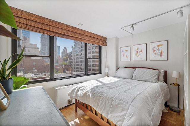 bedroom featuring a city view and rail lighting