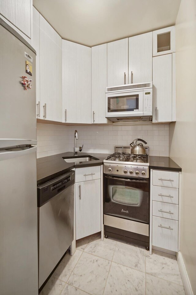 kitchen with sink, white cabinets, and appliances with stainless steel finishes