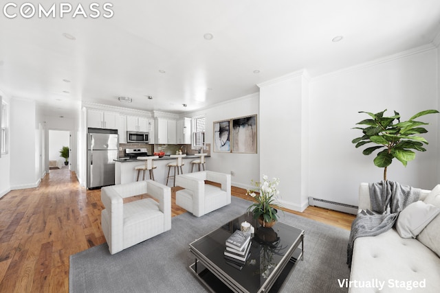 living room with a baseboard heating unit, dark hardwood / wood-style floors, and crown molding