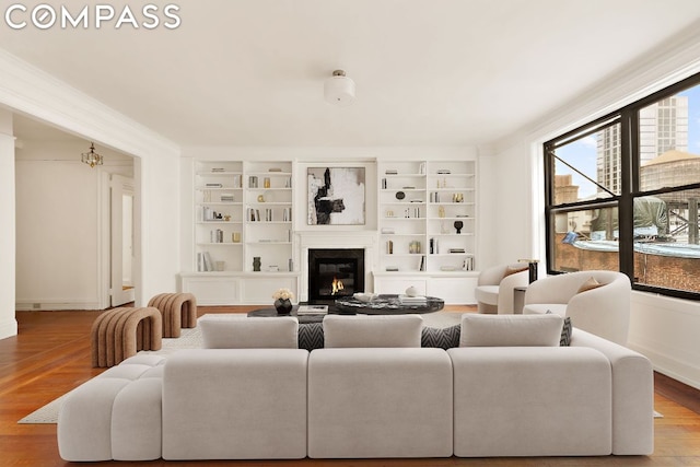 living room with wood-type flooring and built in features