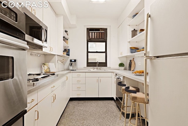 kitchen featuring white cabinetry, appliances with stainless steel finishes, and sink