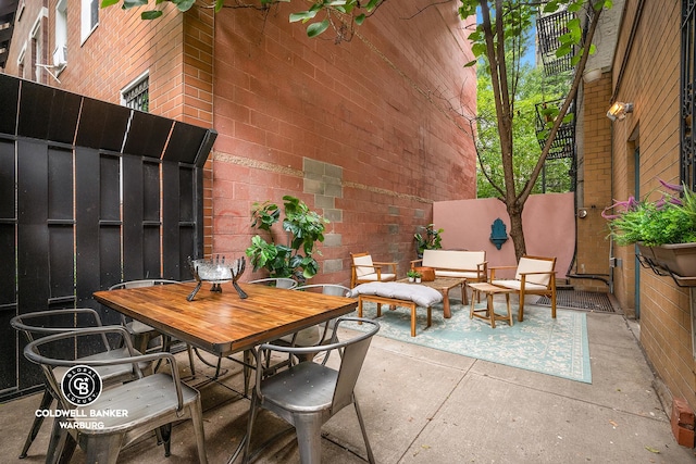 view of patio / terrace featuring fence, outdoor lounge area, and outdoor dining space