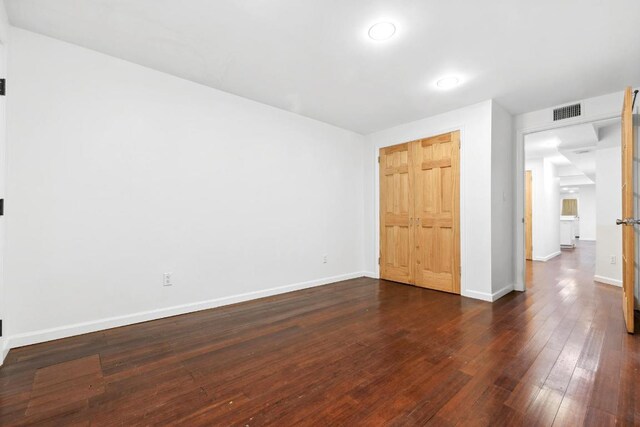 unfurnished bedroom with dark hardwood / wood-style flooring