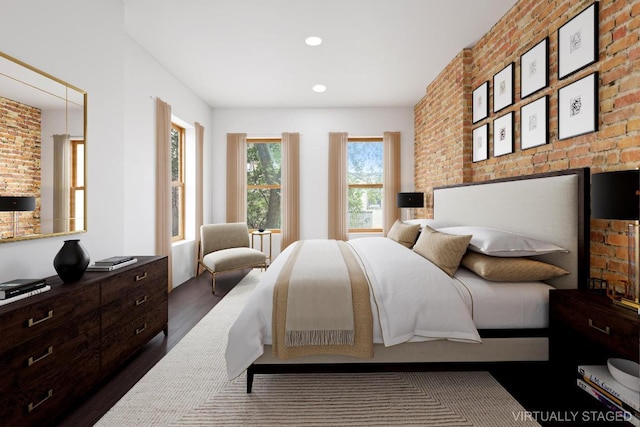 bedroom with dark wood-type flooring and brick wall