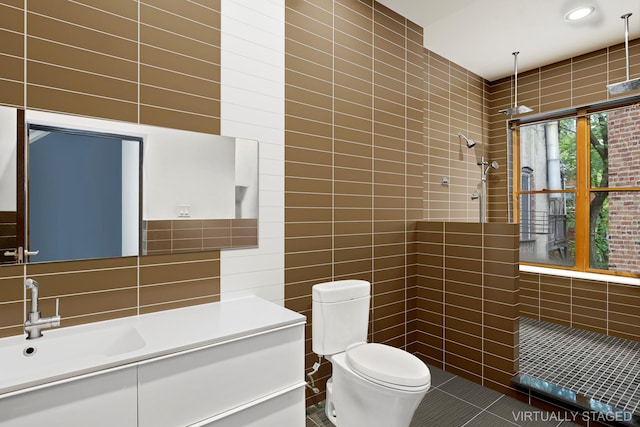 473 W 140th St, New York City, NY 10031 - bathroom featuring tile walls, tiled shower, tile patterned floors, and vanity