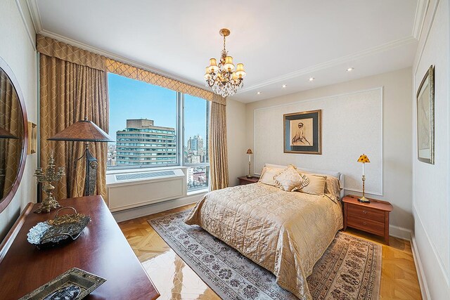 bedroom with a chandelier, recessed lighting, baseboards, and ornamental molding