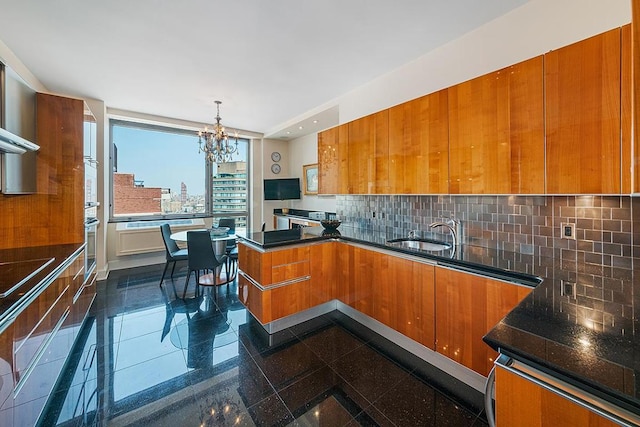 kitchen featuring granite finish floor, a sink, and brown cabinets