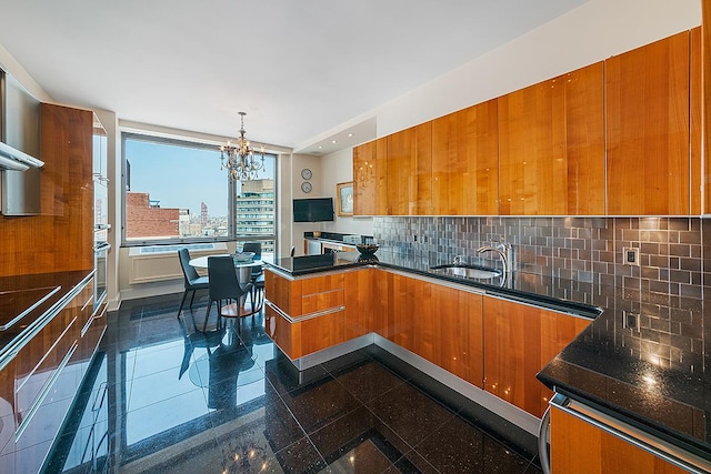 1965 Broadway Unit 26-E, New York City, NY 10023 - kitchen with brown cabinetry, a sink, modern cabinets, a chandelier, and a peninsula