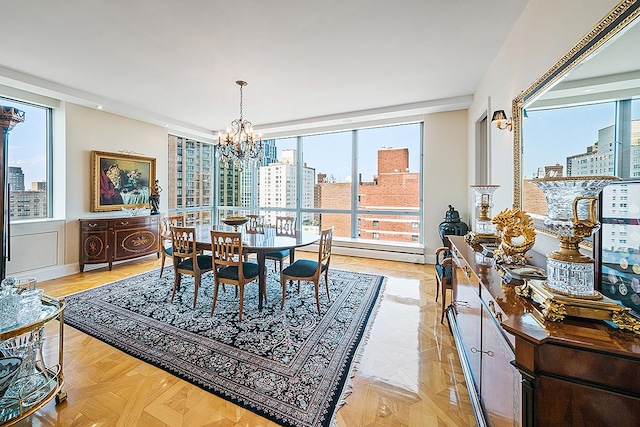 dining room with a view of city, a chandelier, and a baseboard heating unit