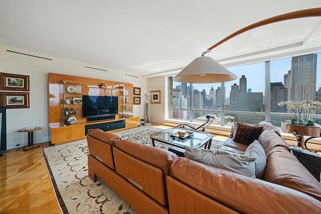 living room with floor to ceiling windows and baseboards