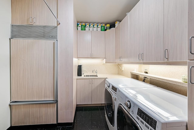 laundry room featuring washer and clothes dryer, cabinet space, and granite floors