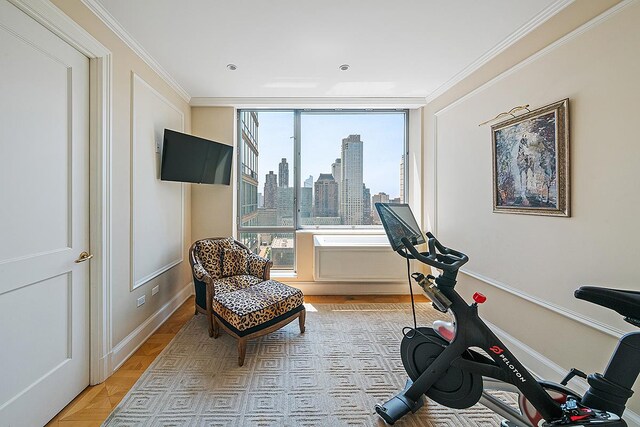 workout area with crown molding and baseboards