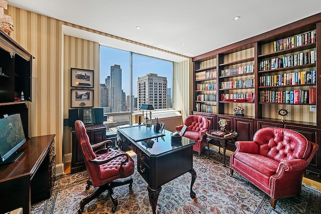 home office with a view of skyline and wallpapered walls
