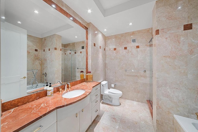 full bathroom featuring vanity, a stall shower, a garden tub, and tile walls