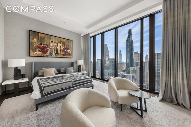 living room featuring hardwood / wood-style flooring, a wall of windows, and a healthy amount of sunlight