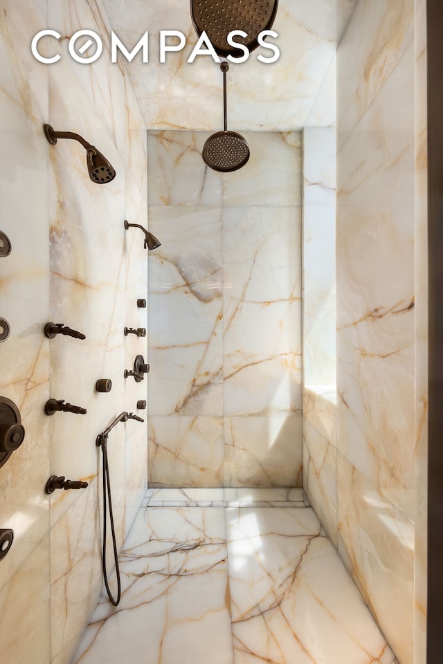 bathroom with a marble finish shower