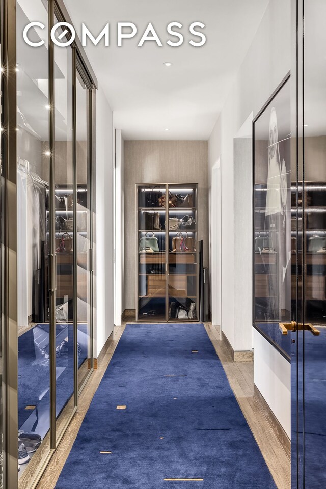 bedroom with hardwood / wood-style floors and floor to ceiling windows